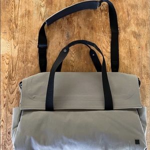 Lululemon messenger computer bag. Grey with black straps and snaps and zipper.
